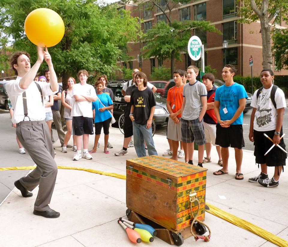 ball spinning on a finger on the sidewalk street performing