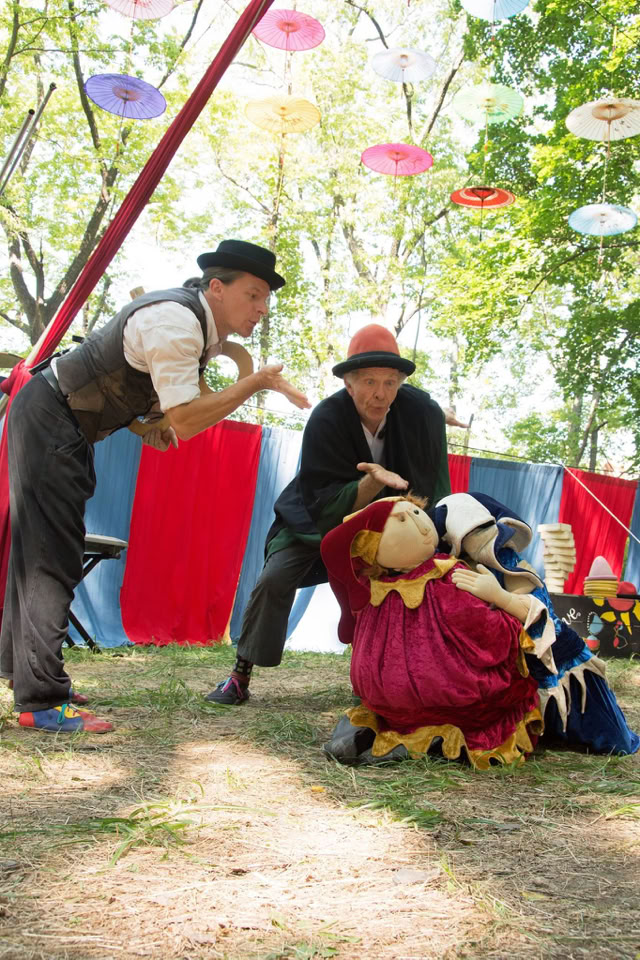 performers blow magic dust on a body puppet 