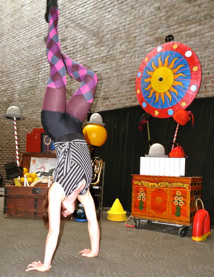 handstand with colorful props 