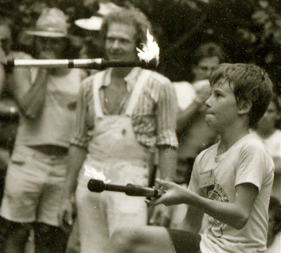 boy juggling fire 1970's b&w
