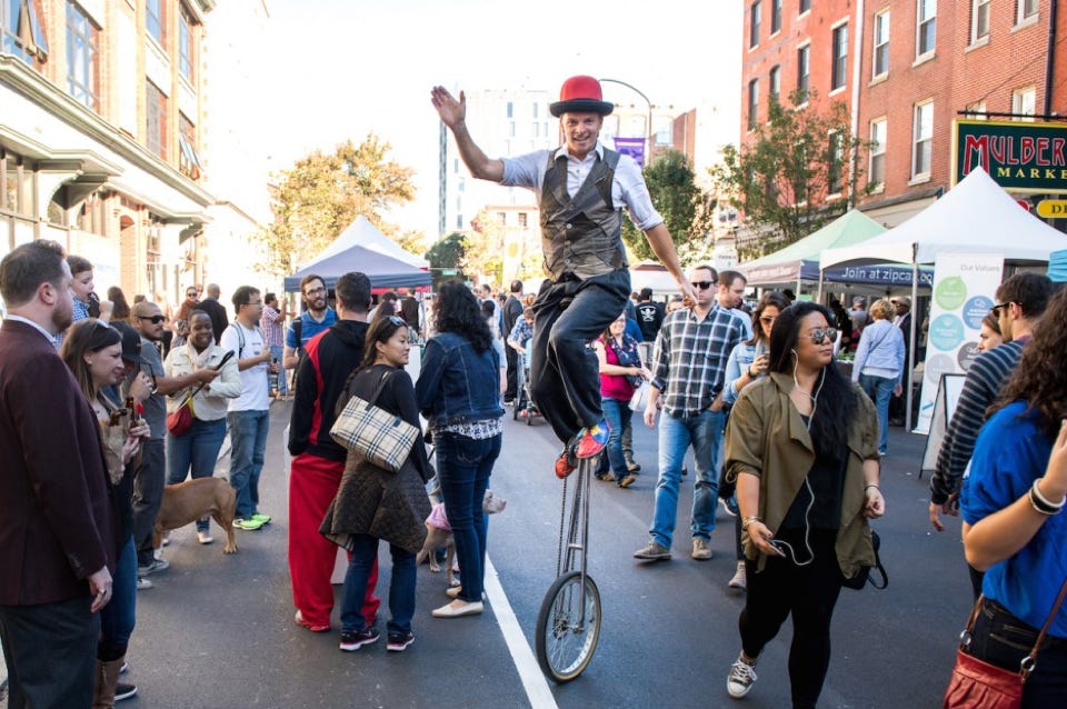 tall unicycle in a street festival