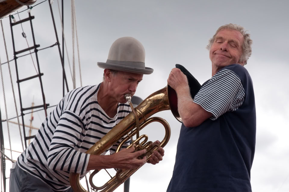 2 men playing with a barritone horn