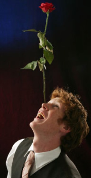 performer balancing a rose on his nose