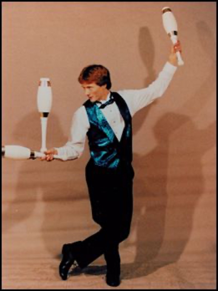 juggler balancing a club and styling